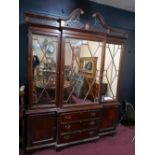 A Georgian style mahogany breakfront bookcase, with broken swan neck pediment, central mirrored