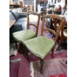 A set of four Victorian inlaid mahogany dining chairs with green velour upholstered seats