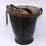 A Victorian stiffened leather fire bucket, with copper banded riveted rim and swing handle, H.30cm