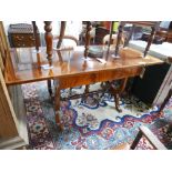 An early 20th century mahogany sofa table, with boxwood inlay, raised on lyre supports joined by