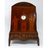 A mahogany and marquetry inlaid watch stand in the form of an arched mantel clock, inlaid with