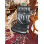 A black leather and chrome adjustable desk chair H.118cm