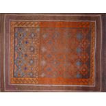 A 20th century Afghan rug with geometric design, on a brown and orange ground, 223 x 149cm