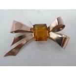 A large vintage, sterling silver and rose gold plated bow brooch centrally set with a stepped-cut,