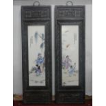 A pair of Chinese hardwood plaques inset with porcelain panels, 120 x 36cm