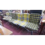 A set of six mid 20th century dining chairs with green button back tartan upholstery, raised on