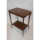 An Edwardian mahogany and boxwood inlaid two tier side table, with shell paterae to top, raised on