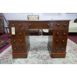 A Victorian mahogany pedestal desk, with green leather skiver and nine drawers, raised on castors,