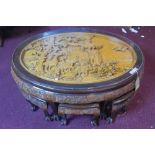 A 20th century Chinese carved hardwood coffee table with stools