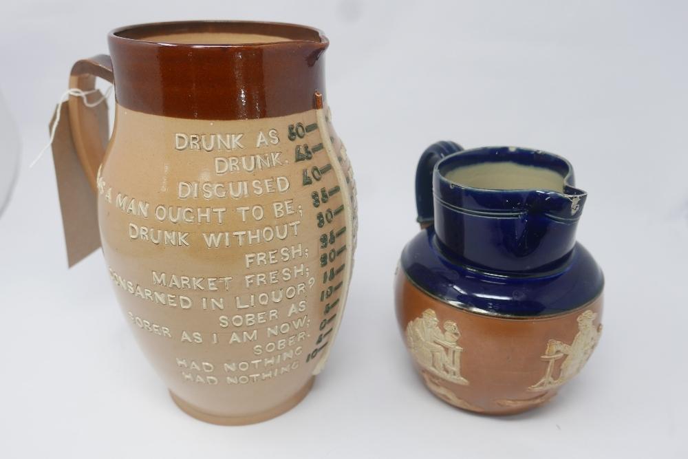 A Doulton Lambeth inebriation measuring jug, impressed marks to base, H.24cm, together with a