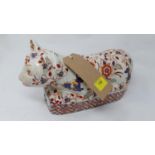 A Chinese, porcelain and handpainted figurine of a seated cat, 15.5 x 30 x 9.5cm, six iron-red