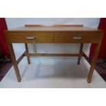 A teak desk with two drawers, on square legs joined by stretcher, H.76 W.102 D.51cm