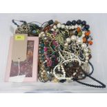 A large quantity of costume jewellery to include many beaded necklaces and a pink box containing