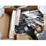 A miscellaneous lot containing a large quantity of cutlery, brass napkin rings, a clock, two books