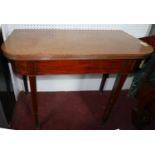 A 19th century mahogany fold over tea table, raised on tapered legs and castors, H.74 W.92 D.45cm