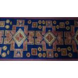 A North West Persian Heriz runner, repeating stylised eagle motifs on a sapphire field, 282 x 89cm