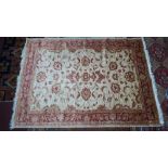 A Ziegler style carpet with floral design, on a beige ground, contained by floral border, 280 x