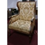 A late 19th century French oak armchair, with floral damask upholstery, carved frame, raised on
