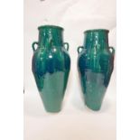 A pair of Persian green glazed Sharab wine vessels, H.88cm (2)