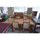 A mid 20th century teak dining table and eight chairs by 'Nathan'