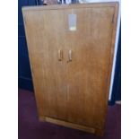 A 1950's oak dwarf fitted wardrobe. H.122 W.76 D.47cm