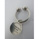 A Tiffany & Co. silver key ring, marked 925, in Tiffany bag and box