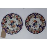 A pair of 19th century Ironstone china plates in the imari palette, 26cm diameter