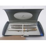 A Boxed set of three Parker fountain pens all in brushed stainless steel