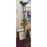 A late 19th / early 20th century wrought iron and coloured castellated standard lamp, with twist