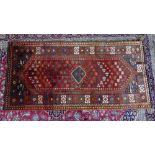 A South West Persian Lori rug, central diamond medallion on a terracotta field within stylised