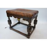 A late 19th/early 20th century oak stool with original leather upholstered seat