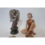 A faux distressed polychrome angel and an Art Deco style figure of a seated girl H.23cm