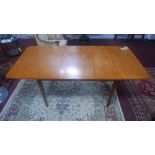 A mid 20th century teak extending dining table, H.74 W.175 D.84cm