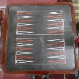 An inlaid games table with chessboard and roulette wheel