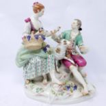 A 19th century Meissen porcelain group of a couple eating grapes on a rocky outcrop, H.20cm