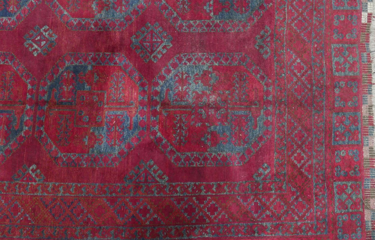 An antique Russian Afghan bokhara carpet, with large gull motifs, on a red ground, contained by - Image 4 of 6