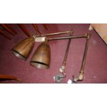 A pair of brass angle poise wall lights