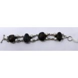 A sterling silver faceted smokey quartz and freshwater pearl bracelet, L: 17.5cm, 46g