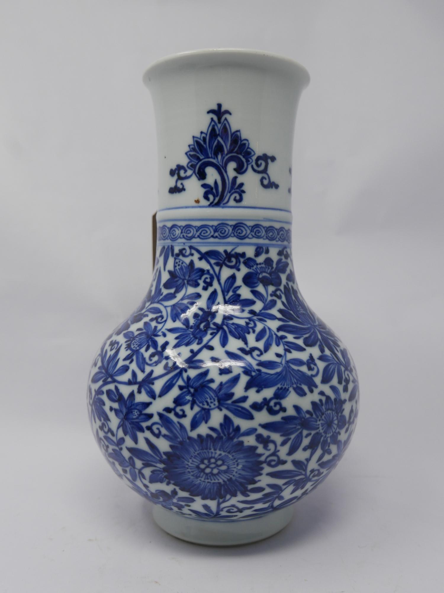 A 19th century Chinese blue & white porcelain vase with floral decoration, small chip to rim and