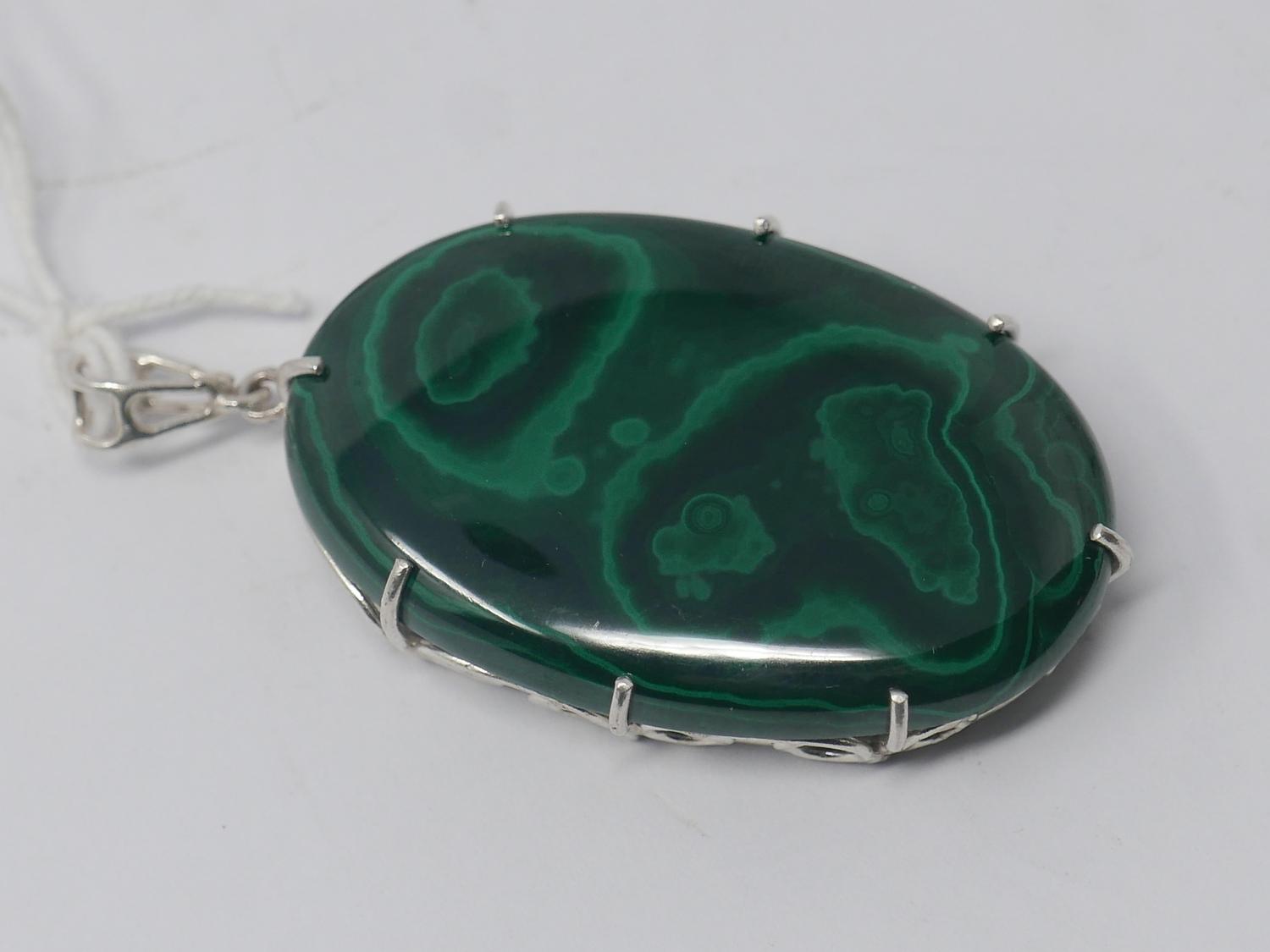 A sterling silver and large malachite cabochon pendant to a sterling silver pendant loop, 6.2 x 3.