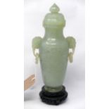 An early 20th century Chinese jade vase on hardwood stand, H.25cm