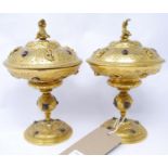 A pair of 19th century Italian gilt bronze tazza's and covers, with figural and floral decoration,