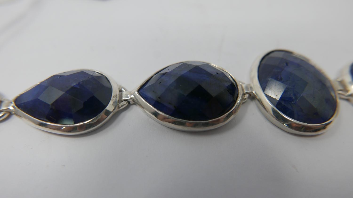A sterling silver and natural sapphire bracelet composed of six graduated tear-drop sapphires and - Image 2 of 2