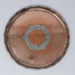 An Arts and Crafts copper and pewter circular tray by Hugh Wallis (1871-1943, Cheshire) decorated