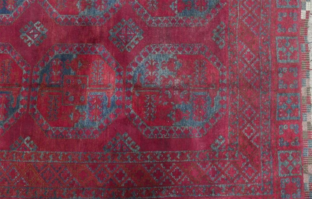 An antique Russian Afghan bokhara carpet, with large gull motifs, on a red ground, contained by - Image 3 of 6