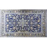 A Kashan rug with double pendant medallion, amongst repeating petal motifs, on a sapphire field,