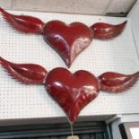 A pair of sheet metal heart plaques