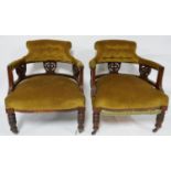 A pair of Victorian mahogany tub chairs, with green velour upholstery, raised on turned legs and