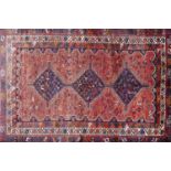 A north west Persian afshar carpet with triple pole medallion amongst repeating geometric motifs, on