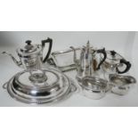 An Elkington & co silver plated four piece tea set together with three plated dishes and a hot water